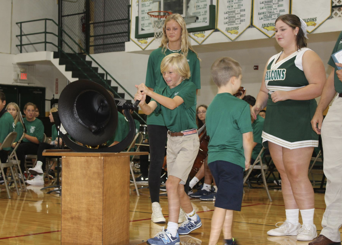 A lower school student rings the bell to bring in the 2023-24 school year at the Opening Chapel